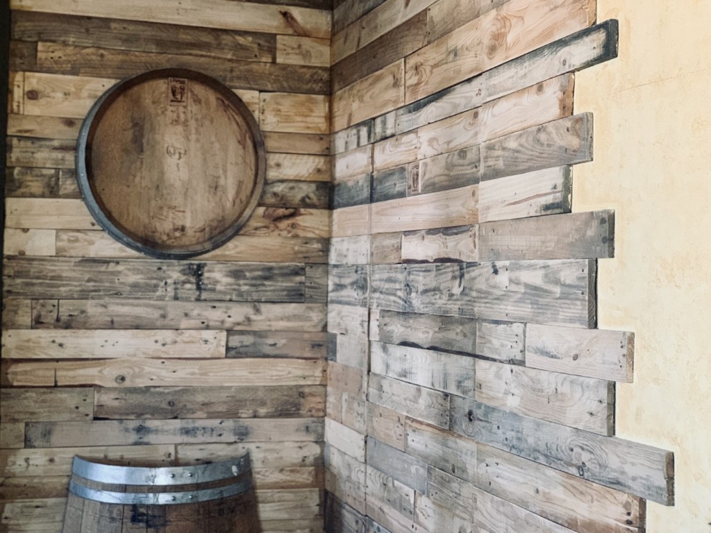 Upcycled pallet wood adorns the wall in the tasting room.